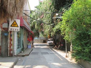 single lane stretch of street that continues on from Xia ao zi. Photo shows approaching end of this with Ding ao zi cat street obscured off to the right at Green Market in Xiamen