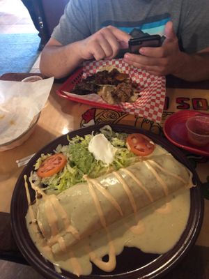 burrito covered in cheese at Taqueria Los Mayas in Cheektowaga