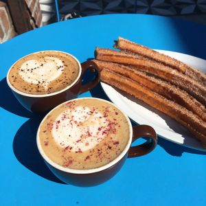 Beautiful specialty lattes and churros. at Cocoa Cinnamon - Lakewood in Durham