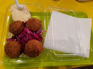 The falafels with hummus, and salad underneath at Hummus Bar in Belgrade
