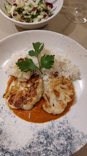 Cauliflower steak, curry sauce. at Gaudi&Naan in Ljubljana