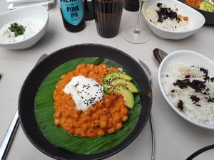 Curry served with rice and a sauce at Gaudi&Naan in Ljubljana