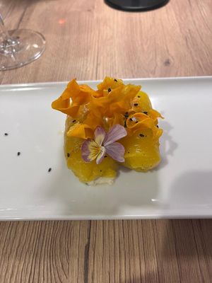 Tangy yellow peppers wrapped around cream cheese with parsnip(?) crisps and black sesame seeds at Gaudi&Naan in Ljubljana