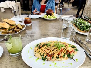 From L clockwise: banh mi, Oliver’s burger, pear and Gorgonzola flatbread, spinach and artichoke flatbread (please order!) at Oliver's in Santa Barbara