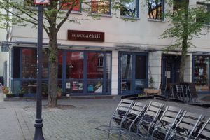Café entrance and outdoor seating area at Moccachili in Saarbrucken