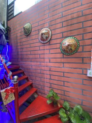 Stairway with nice hats  at Nook Eatery in Hue
