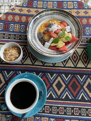 Mango smoothie bowl and black coffee  at Nook Eatery in Hue