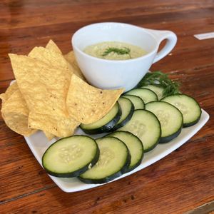 Hummus, chips, & cukes—the hummus is a delicious dilly dip kind of hummus. 🤤   at Two Dollar Radio Headquarters in Columbus