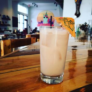 The "Stewart in Paradise" cocktail: OYO Stonefruit vodka, lime juice, coconut milk, shaken over ice. at Two Dollar Radio Headquarters in Columbus