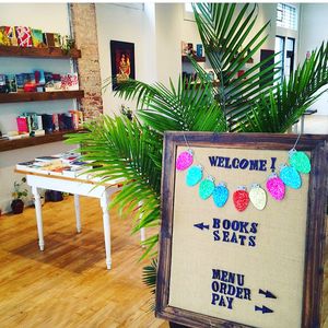 Two Dollar Radio HQ interior welcome sign at Two Dollar Radio Headquarters in Columbus