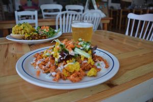 Kimchi Plate: House-made Kimchi stirfried with rice and a spicy Gochujang sauce, topped with raw veggies and our tofu scramble and roasted garlic aioli drizzle. GF NF at Two Dollar Radio Headquarters in Columbus