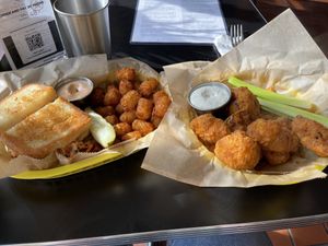 (left) Bahn Mi [in exile] with tater tots and Yum Yum Sauce (right) 1/2 order Buffalo Cauliflower Wings  at Detroit Street Filling Station in Ann Arbor