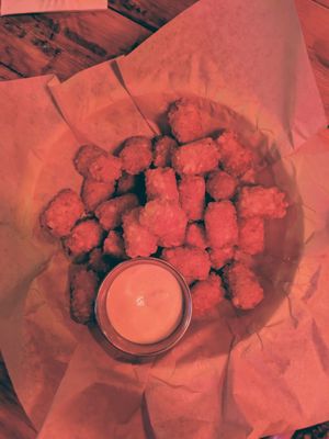Tator tots with yum yum sauce at Detroit Street Filling Station in Ann Arbor