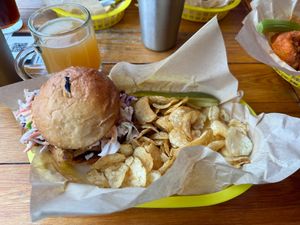 Mushroom Sandwich (Chick'n Style) with pickle spear and chips; Mulled Michigan Cider in back left corner at Detroit Street Filling Station in Ann Arbor