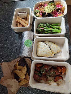 From top, churros & nachos. Long stem broccoli side dish. Mushroom Burrito & Black Bean Quesadillas. Sweet potato side dish. at Wahaca in Edinburgh