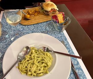Vegan burger and patatas, non-vegan pesto noodles (cheese and egg) at El Astronauta in Cordoba