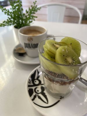 Yoghurt, granola & fruit bowl with oat milk coffee  at Vegan Bombon in Alicante