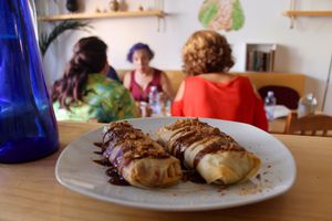 Cruncky rolls filling with quinoa, roasted vegetables and a special sauce made with almonds and cinnamon.  at Amelie Green in Gran Canaria