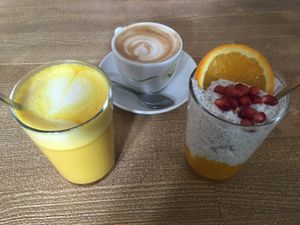 Golden trio: Kurkuma Latte, Cappuccino, Chia Mango Yoghurt  at Mana - Schöneberg in Berlin