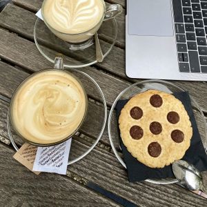 Coffee with rice mylk and vegan chocolate chip cookie at Mcc Cafe in Celje