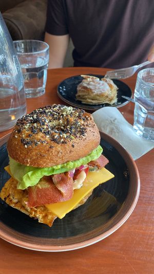 Breakfast bagel + what’s left of our lemon cinnamon roll   at Bite Me Cafe in Madrid