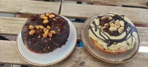 Donuts de chocolate negro y kikos y de chocolate blanco y manises at Bite Me Cafe in Madrid