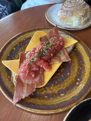 Tostada con tomate, queso y vacon   at Bite Me Cafe in Madrid