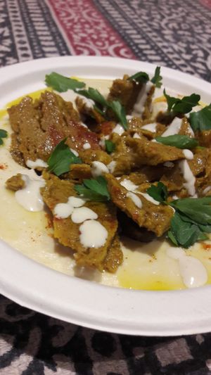 Vegan Shawarma (middle eastern kebab) over classic hummus and green tahini!!! Add some spicy home made chilli salsa and clean up the bowl with freshly baked pita bread.. at Hamsa Hummus Bar and Vegan Shawarma in Melbourne