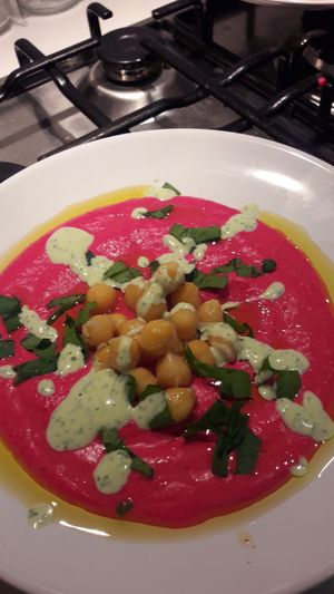 Beetroot hummus with green Tahini 
Wipe the bowl clean with freshly baked pita bread  at Hamsa Hummus Bar and Vegan Shawarma in Melbourne