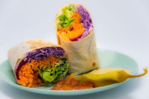 Pakora master wrap : sweet potato pakora,  hummus, ginger sesame coleslaw, rocket, tomato, pickle, carrot and coconut salad. leaves, mango chutney, chilli and sate sauce, love at Master Foody Moody's in Margate