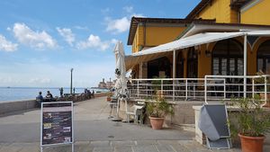Outdoor and indoor seating at Caffe Teater in Piran