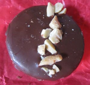 A vegan alfajor. Two cookies with homemade peanut butter and raspberry jam in between, coated with chocolate.  at Ranita Lilo Reposteria Vegana in Valparaiso