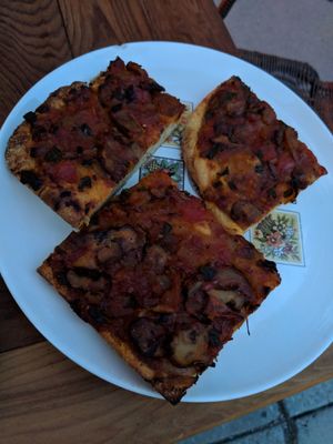 Pizza!  Toppings change every day, on this day it was onion and lobster mushroom at Strange Town in Milwaukee