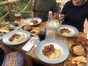Wider table shot showing drinks and patatas bravas type dish to the far right  at Eden Project in St Austell