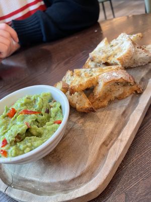 Avocado with garlic bread  at Wulf & Lamb Chelsea in London