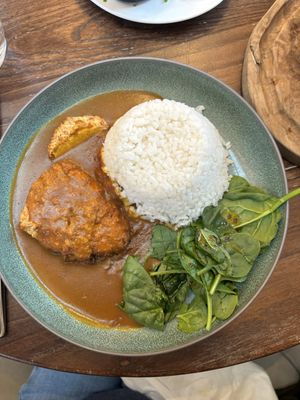 Katsu curry - barely any sauce and wilted spinach on the sidee  at Wulf & Lamb Chelsea in London