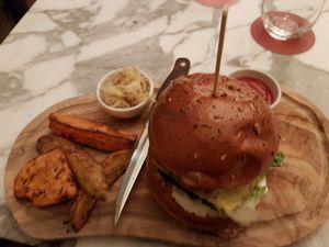 The Wolf Burger! I thought this was quite a nice burger. It came with optional sauerkraut on the side, optional cheese (not sure which brand) and 4 delicious wedges. at Wulf & Lamb Chelsea in London