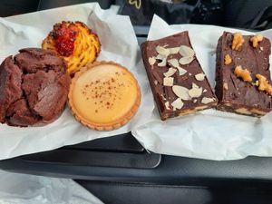Chocolate muffin, coconut biscuit, custard tart, almond slice and walnut slice(left to right) at La Panella in Preston