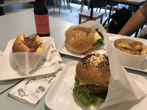 Pastrami Burger, Tempeh Burger, Hot Dog and Potatoes  at Krowarzywa in Wroclaw