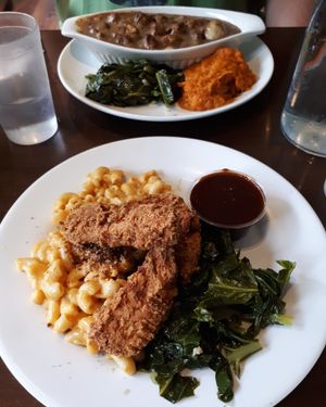 Southern Combo (fried unchicken, BBQ sauce, mac and cheese, and sautéed collard greens). Vegan beef and dumpling stew with sweet potato mash and collards. at The Hogtown Vegan in Toronto