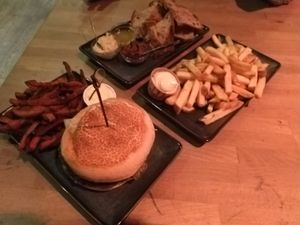 Green Oatburger, Sweet potato fries, French fries and bread with different toppings. at Backstage Vegan Kitchen in Rotterdam