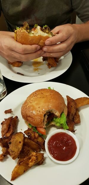 burger + cheese burger in hands at The VOV in Negombo