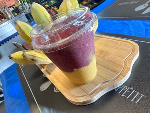 Purple Rain Smoothie, mango banana in bottom and blueberry pineapple on top at Vegan Farmacy in Fort Pierce