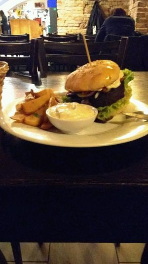 seitan burger with potato fries at Tři Ocásci in Brno
