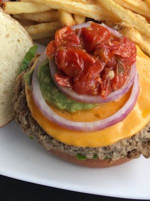 Food was VERY good.  While visiting the Chicago area we found this place!  The burger pictured is called the Converge
6oz Impossible Burger, Cherry Tomato Jam, Avocado Mash, Cheddar (v), Roasted Garlic Mayo (v), Baby Arugula, Red Onion.  Fries are technically not vegan so my husband ate those.   at Kuma's Corner in Schaumburg