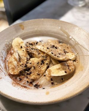 Banana Tahini Porridge with almond milk instead of dairy milk at 26 Grains in London