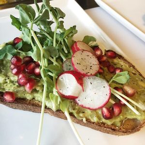 Smashed Avocado Toast served on bread from Fife Bakery at Roots + Fruits in Vancouver