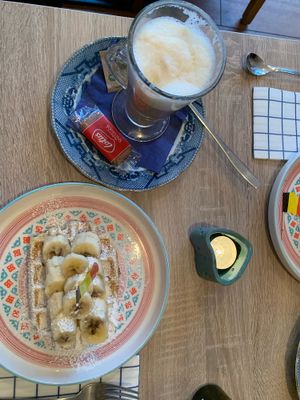Latte and waffle with banana at Charlotte's by De Brugsche Tafel in Bruges