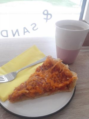 Tomato vegetable quiche with vegan cheddar and latte (white coffee, locally) with rice milk. at Green Bean in Brezice
