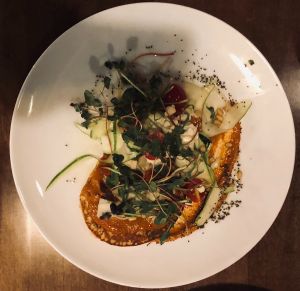 Ferinata: chickpea cake, muhammara, zucchini, tomato, cauliflower, lemon dressing, toasted chia seeds, pine nuts at Twisted Fern in Park City